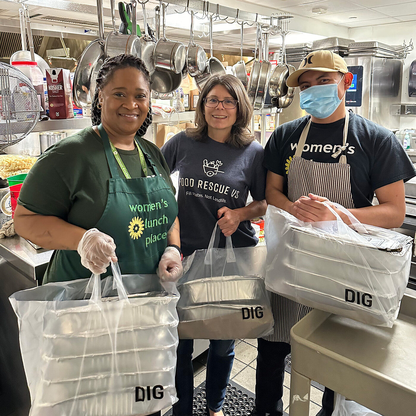 FRUS Boston volunteer with DIG employees and food donation